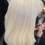 Person with blonde hair in a salon setting