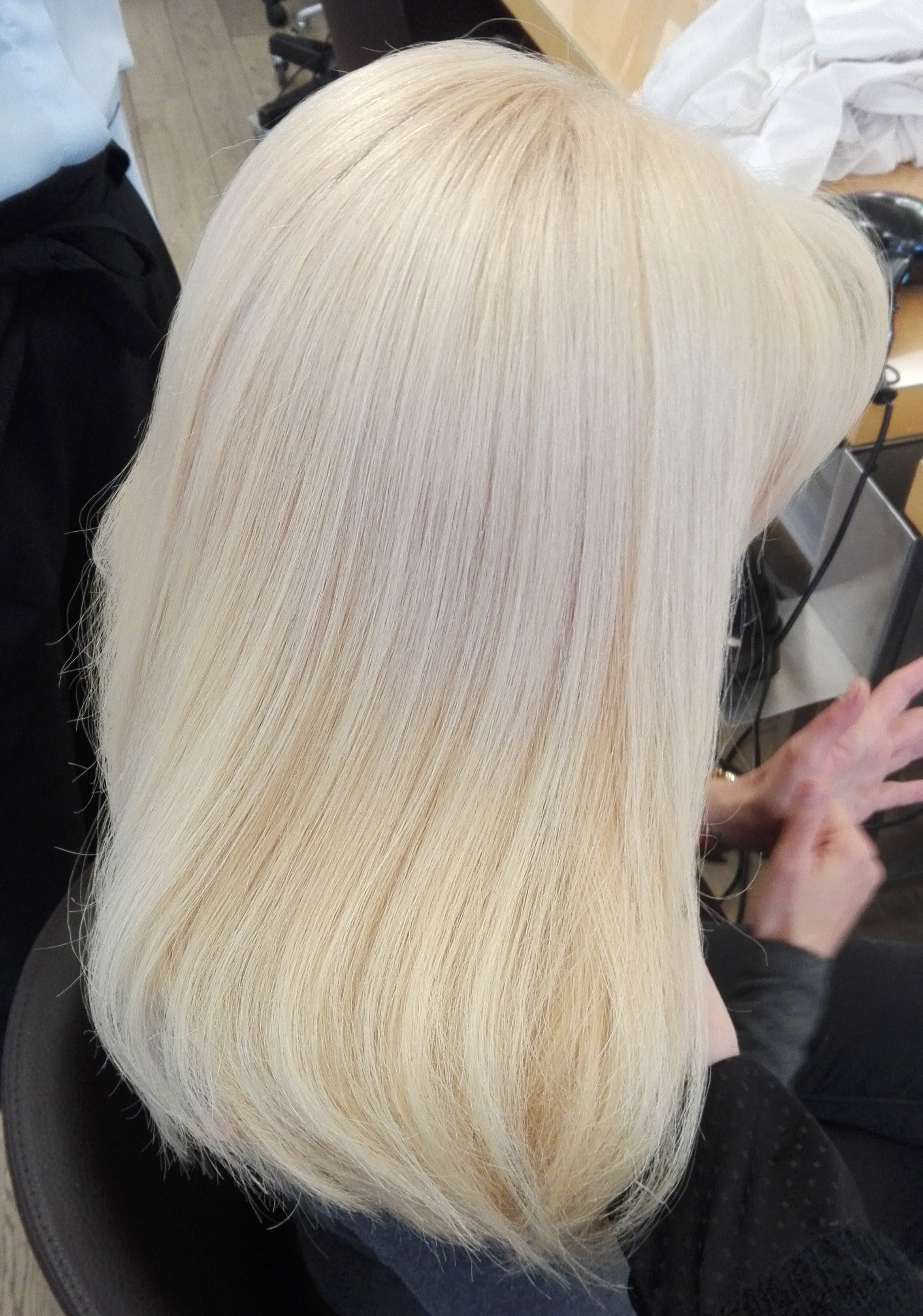 Person with blonde hair in a salon setting
